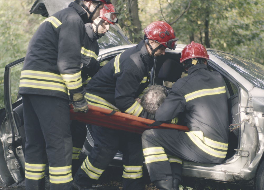 Emergency crews assisting a driver after a collision