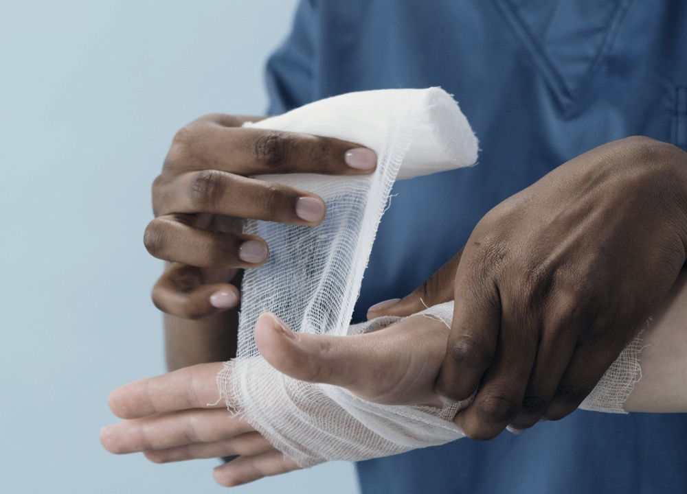 A clinician wrapping an injured hand